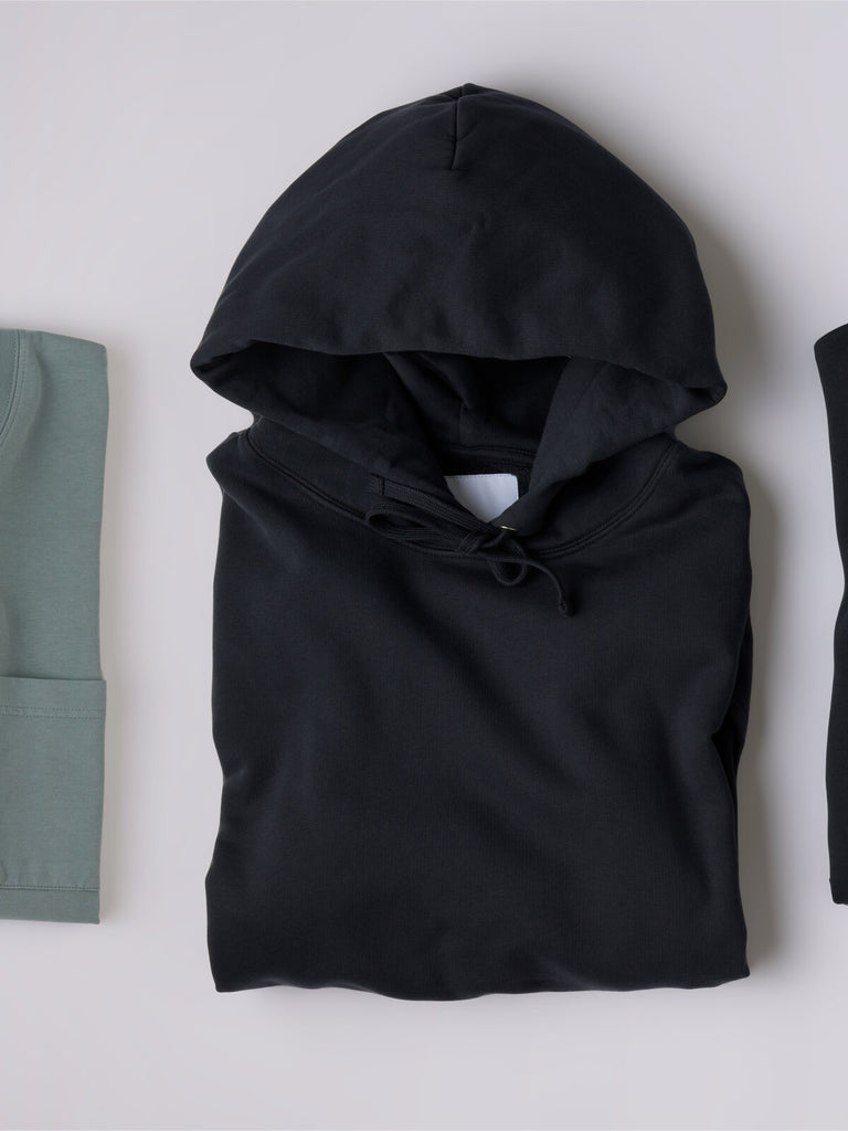Core Hoodie - Navy — folded front view, showing hood and drawcords.