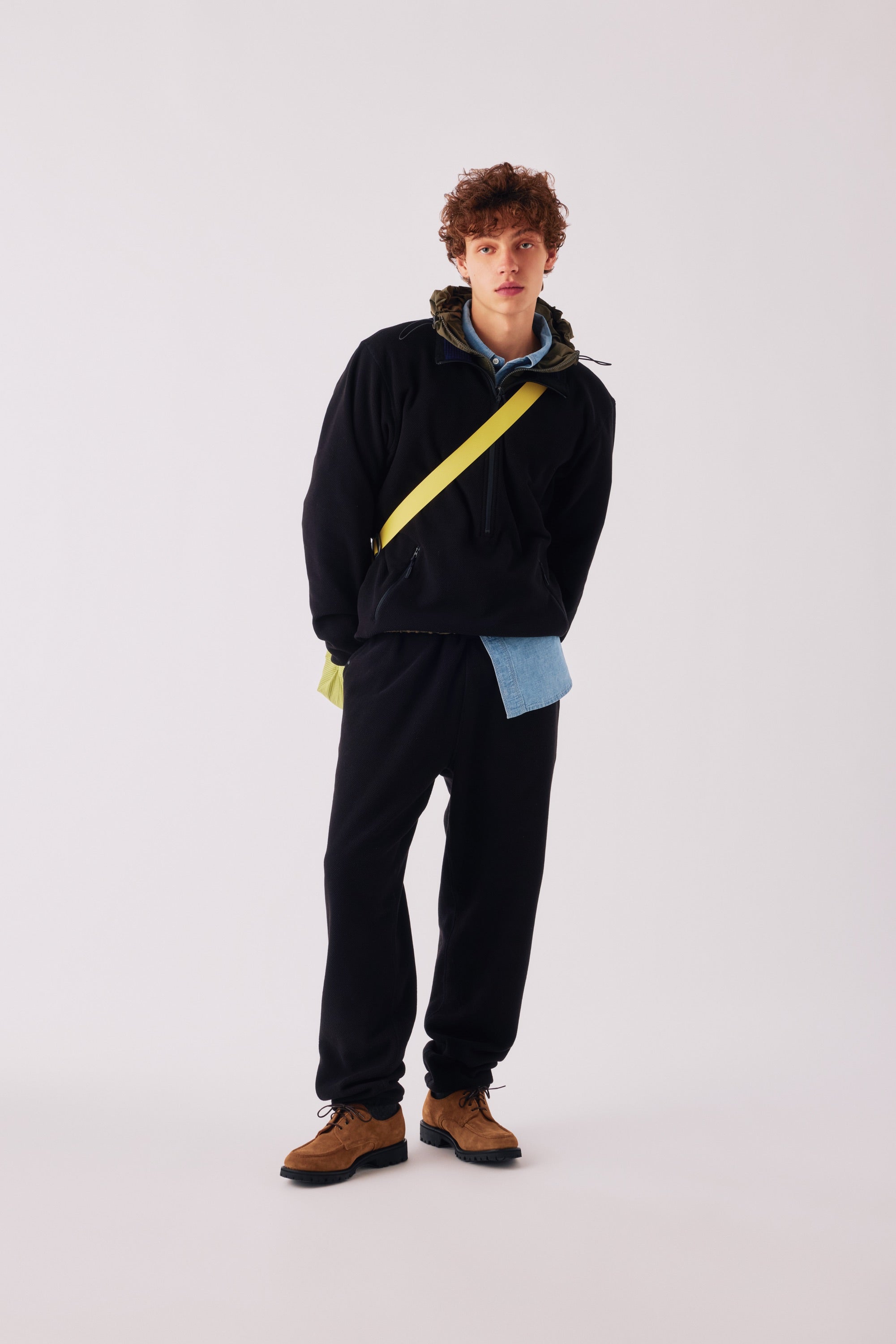 Adsum FW26 — model in a black fleece pullover and black pants
